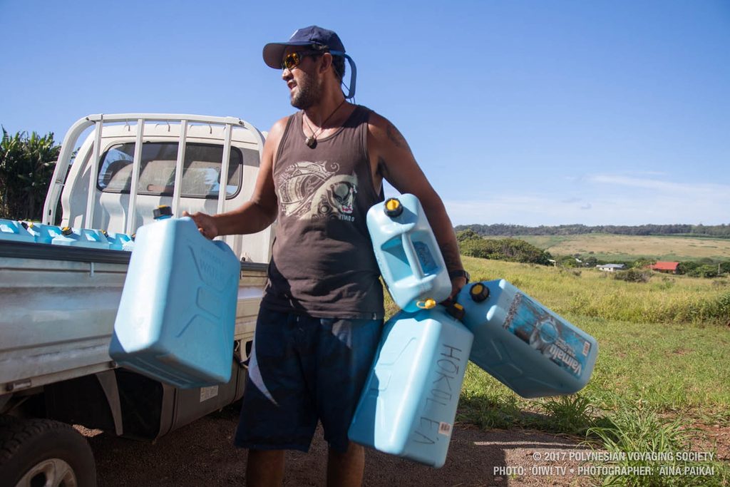 Ben helps off load water jugs