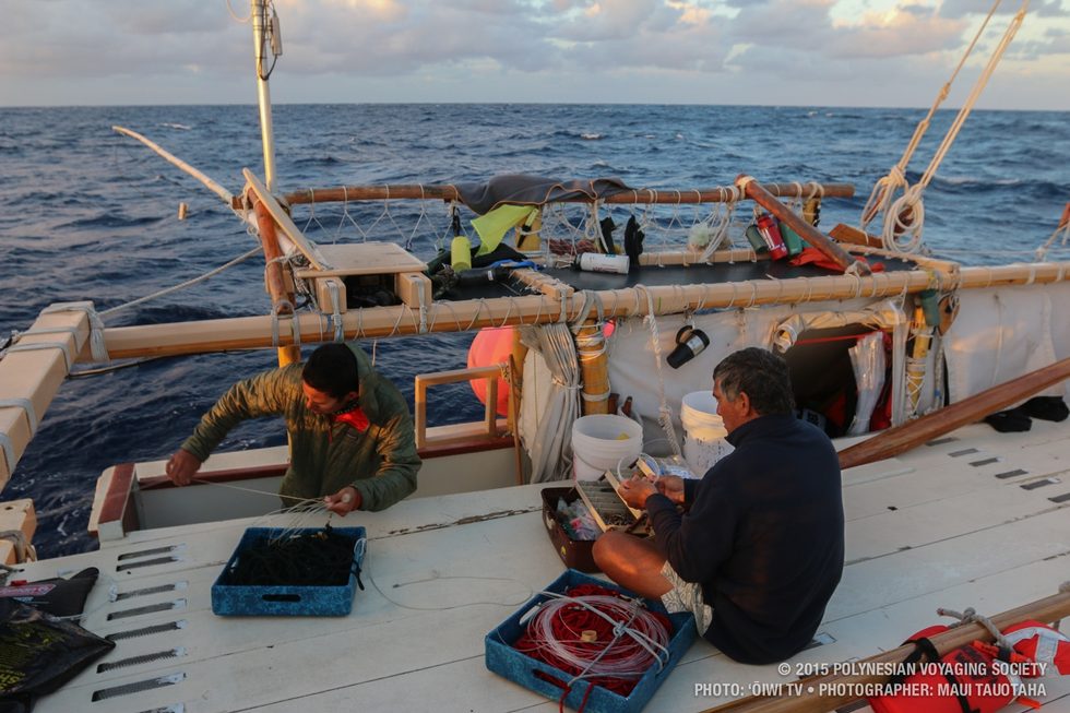 Kaleo and Captain Bruce putting out fishing lines in the morning.