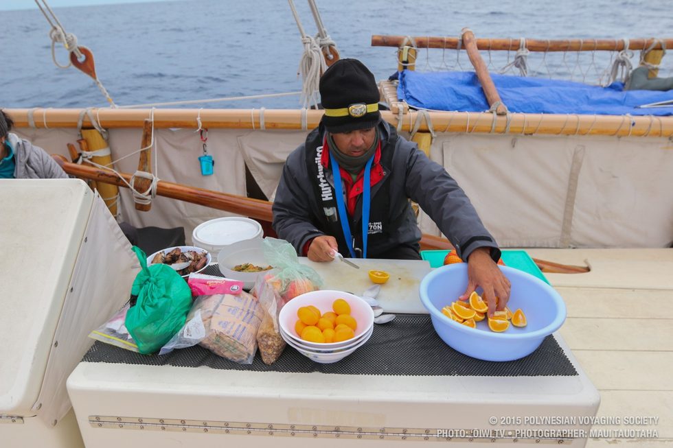 Kawika slicing oranges.