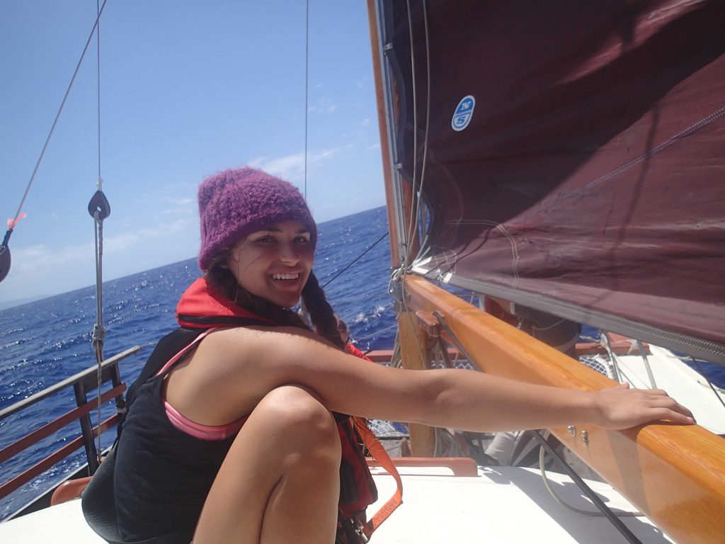 Kalikolehua adjusting the main sail from on top of the hale. A hardworking crew member, Kaliko took on various kuleana: chef, cultural guide, and student of navigation. Double-majoring in Meterology and ‘Ōlelo, she is fluent in both weather patterns and Hawaiian language.