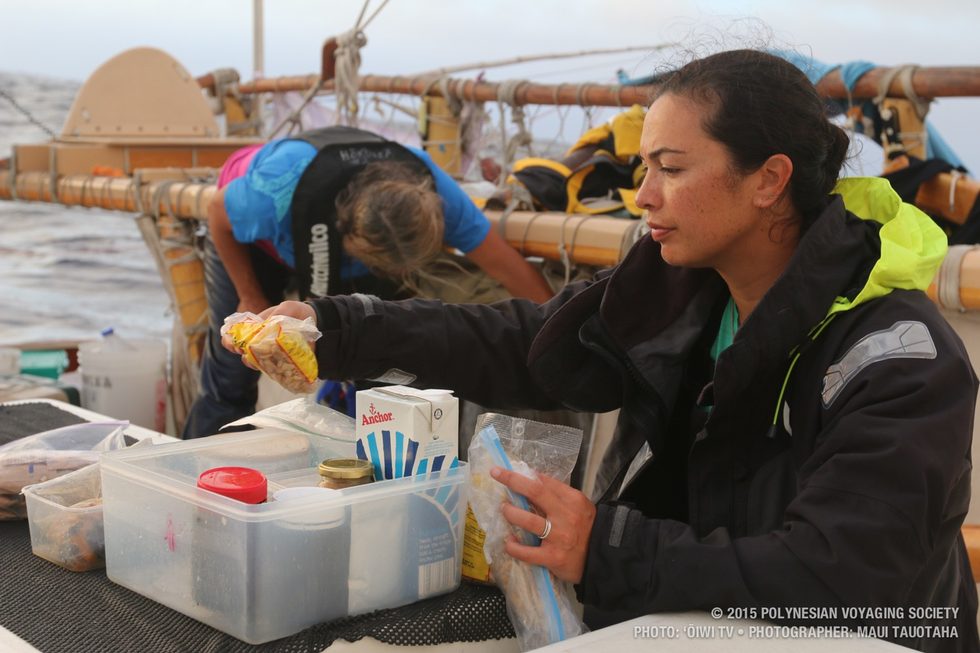 Ana checking the snack box on deck.