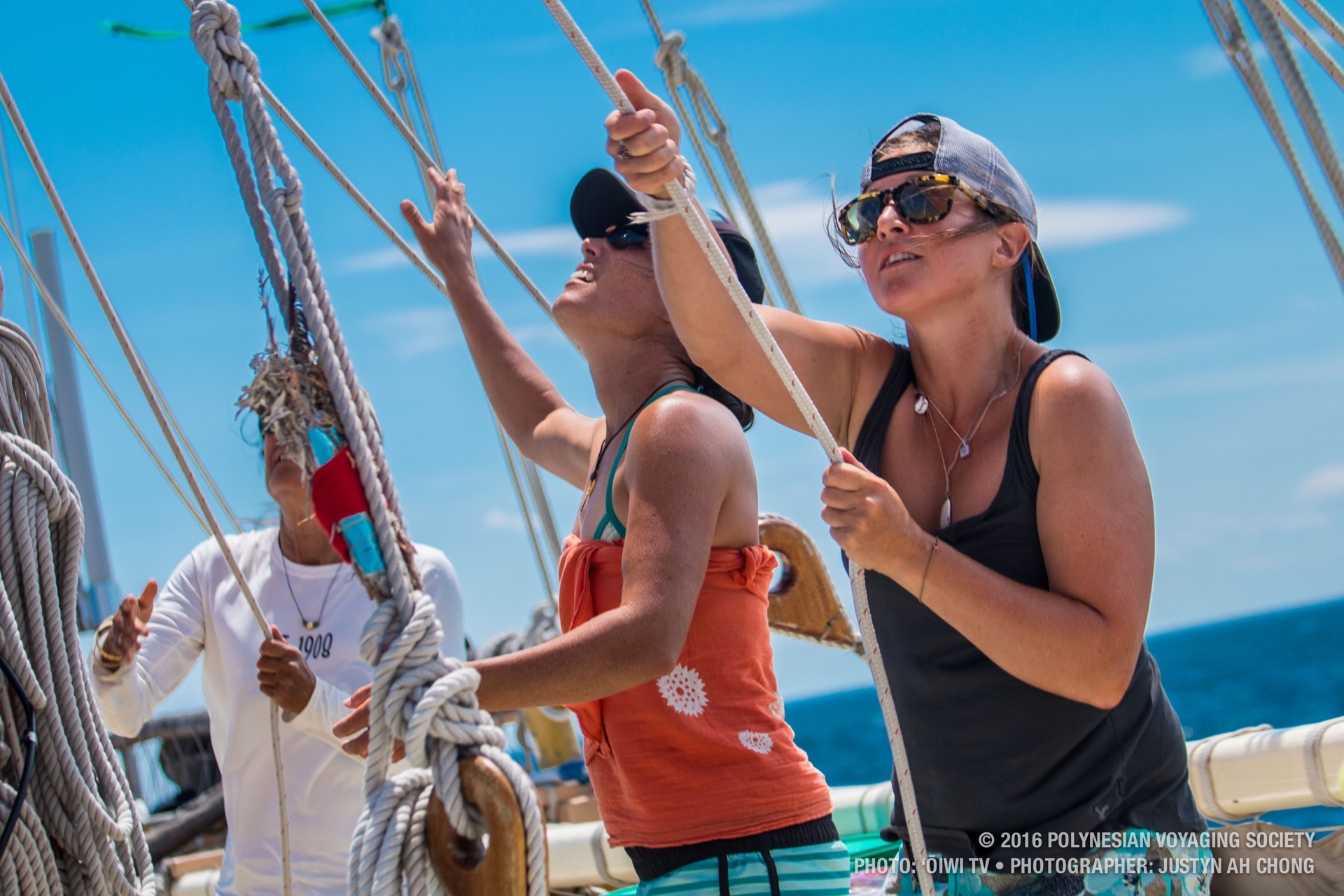 Shelly Knoetgen and Kaʻiulani Murphy run sheet lines to open up sail.
