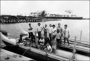 The first crew of Hōkūleʻa stands proud in Honolulu Harbor .