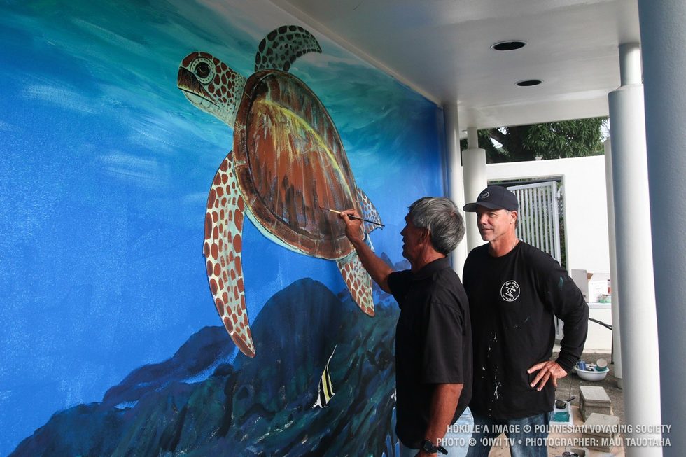 Nainoa touching up Wyland’s honu mural