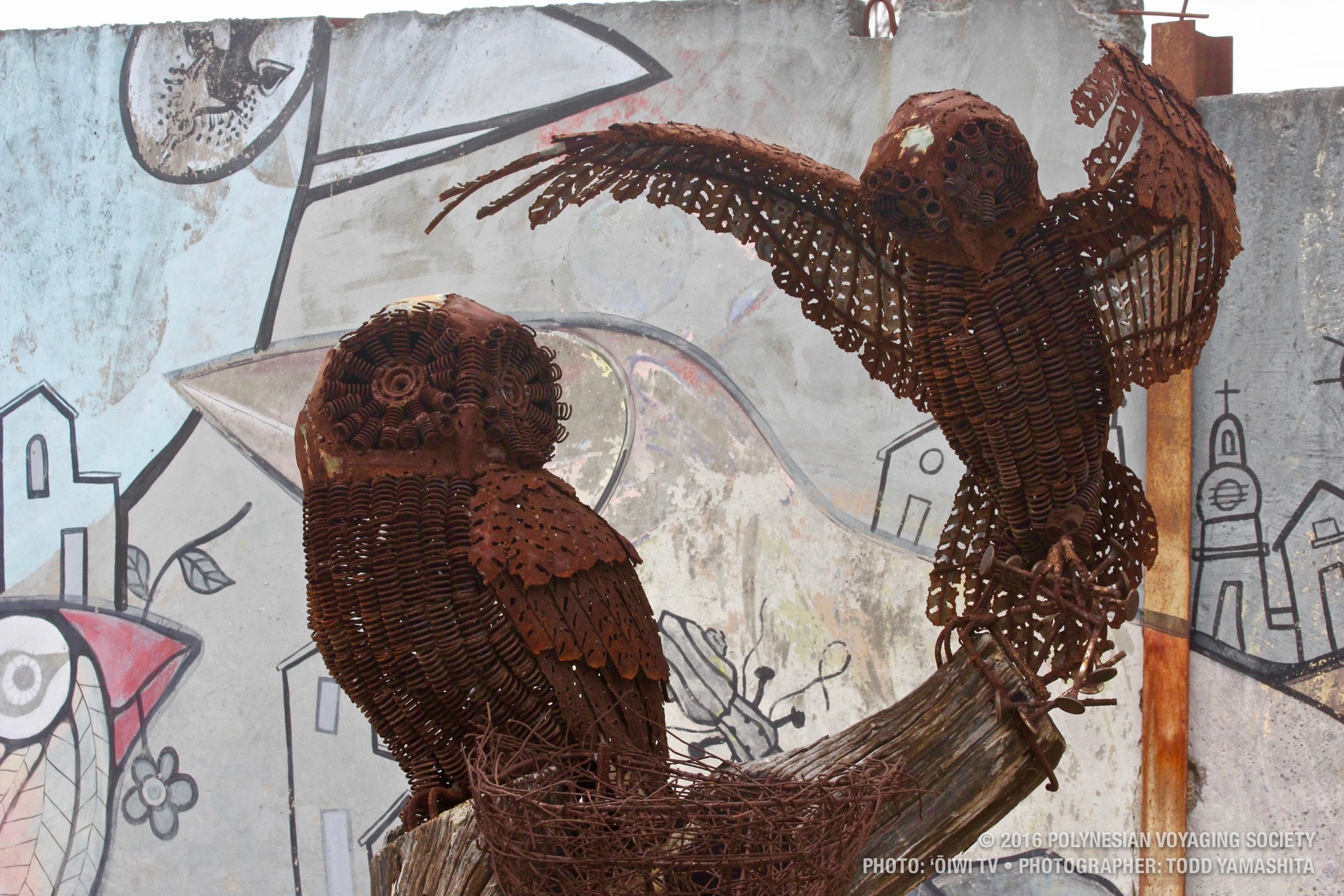 A pair of owls sculpted from scrap metal.