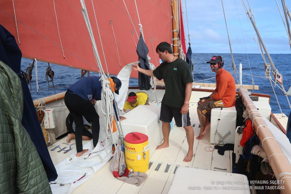 Folding the jib while Kaleoprepares for his daily navigation report.