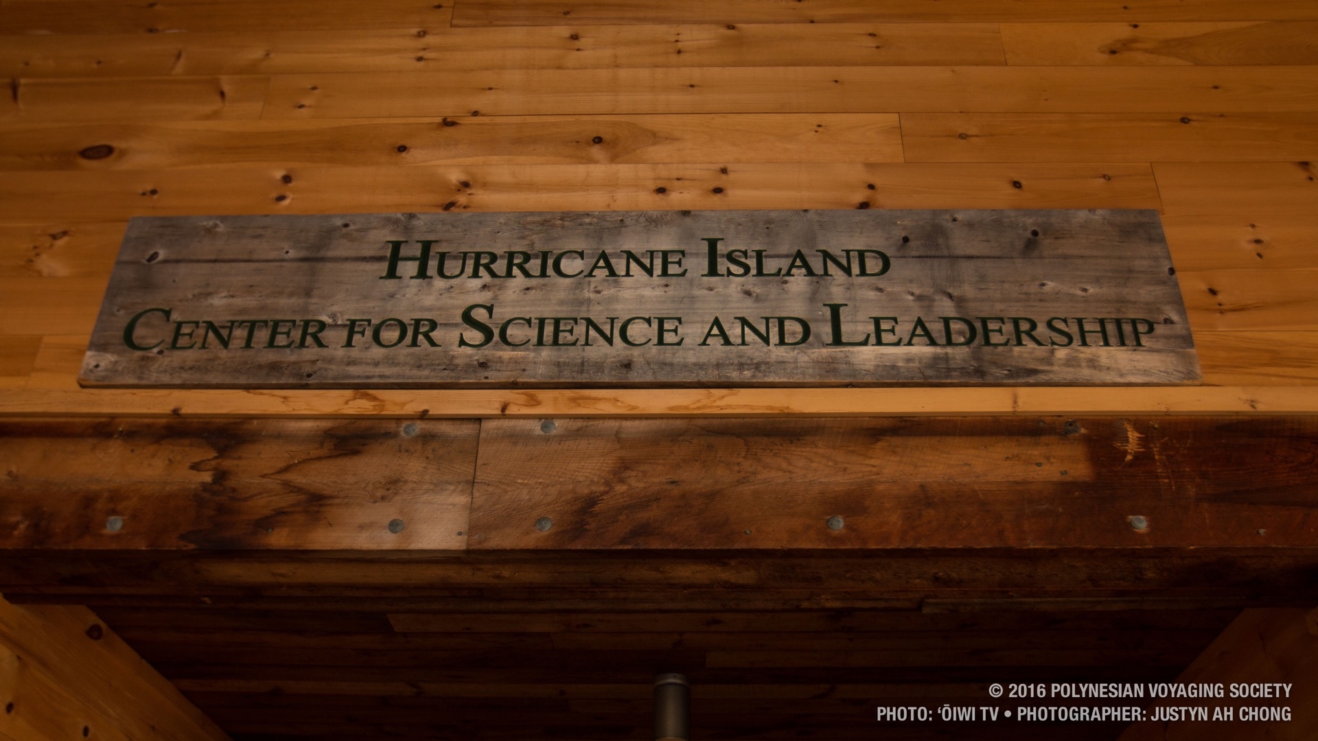 A sign for the foundation hangs up in the meeting hall.